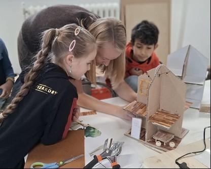 A simple logo with the name "Kaiser Lodge". It features a stylized, geometric design in soft colors.