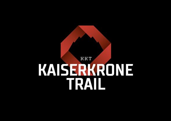 A modern logo for the Kaiserkrone Trail. It features a stylized mountain in red and black lettering.