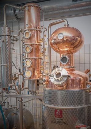 Eine Kupferdestille in einer Brennerei. Die Anlage zeigt moderne Technik zur Spirituosenherstellung.