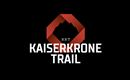 A modern logo for the Kaiserkrone Trail. It features a stylized mountain in red and black lettering.