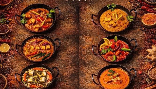 A selection of six different Indian dishes served in traditional pans. The dishes are colorfully arranged and garnished with fresh herbs.