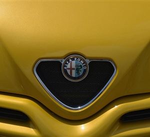 A yellow car with the iconic Alfa Romeo logo. The front section displays a sporty and appealing style.