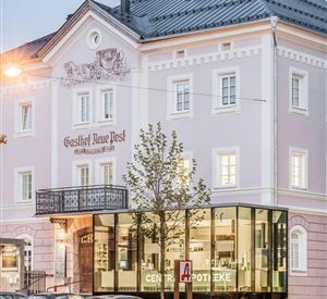 Een elegant gebouw met een klassieke façade en een moderne glazen kubus. Het hotel heeft een uitnodigende sfeer en een verzorgde buitenruimte.