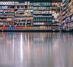 A supermarket shelf with a variety of packaged foods. The colors and shapes of the products are clearly visible.