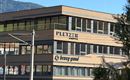 Ein modernes Gebäude mit Holzfassade. Die Unternehmensnamen "PLETZER" und "brewa grund" sind deutlich sichtbar.