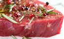 A juicy piece of meat with colorful pepper and fresh herbs. The surface is shiny and enticingly seasoned.