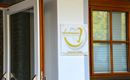 An entrance with modern signage for a dental clinic. The glass front and wooden framed window create an inviting atmosphere.