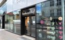 A modern store with a large glass front. It is a Hunke Müller shop that displays underwear in the window.