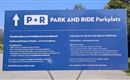 An information sign for the P+R parking lot in Scheffau. It contains instructions for the use and payment of the parking lot.