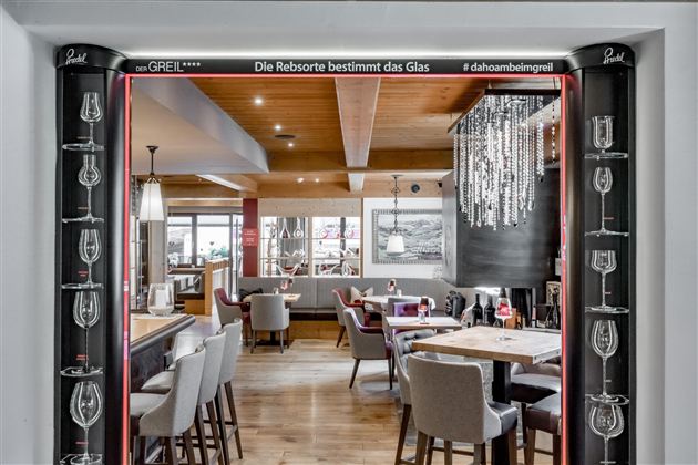An elegant restaurant with stylish interior and a cozy atmosphere. The lighting and decoration create an inviting mood.