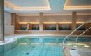 An elegant indoor pool with a bright and modern design. Relaxation areas with comfy loungers invite you to stay.