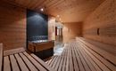 A modern sauna made of wood with a calm ambiance. The benches are evenly arranged, and the relaxing atmosphere invites you to unwind.