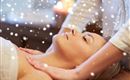 A woman receives a relaxing massage. Gentle snowflakes have a calming effect in the background.