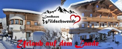 Ein gemütliches Landhaus im winterlichen Ambiente mit schneebedeckten Bergen im Hintergrund. Der Schriftzug "Urlaub auf dem Lande" betont die ländliche Idylle.