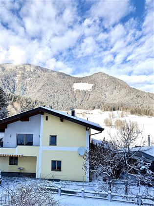 In this yellow house, all 3 apartments are located. You can experience this landscape in winter in Söll.