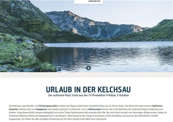 A beautiful mountain lake surrounded by tall mountains and a clear blue sky. The landscape is peaceful and invites relaxation.