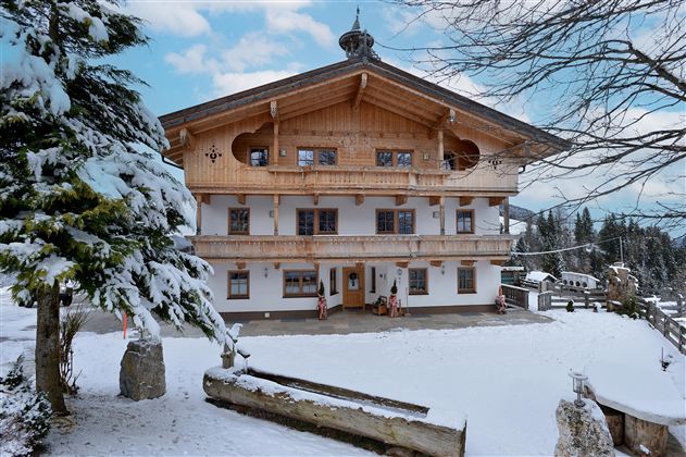 Een charmant, rustiek gebouw in een sneeuwbedekte omgeving. De gevel toont traditionele alpine architectuur en een uitnodigende sfeer.