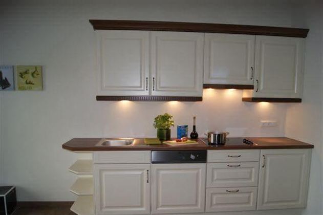 A modern country house kitchen with refrigerator, dishwasher, and fully automatic coffee machine awaits you