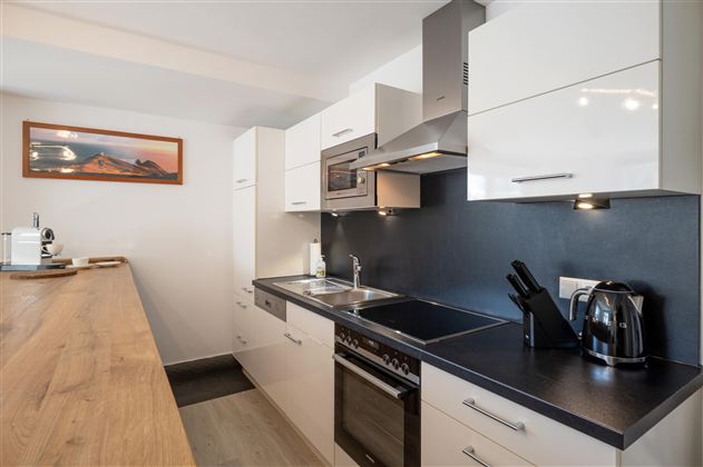 Moderne Küche, die mit sämtlichen Küchen- und Kochutensilien ausgestattet ist. Die Küche mit angrenzender Bar und Barhockern befindet sich in einem großzügigen Esszimmer für bis zu 6 Personen.
