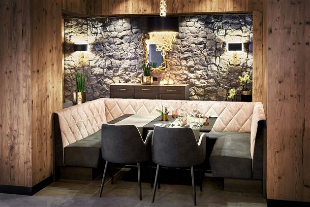 A modern restaurant with comfortable seating and elegant wooden paneling. The atmosphere is cozy and inviting.