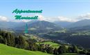 Et smukt landskab med grønne bakker og bjerge i baggrunden. I forgrunden er stedet "Appartement Mariandl" markeret.