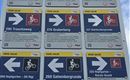 Een informatiebord met verschillende fietspadenborden. De routes zijn duidelijk gemarkeerd en tonen richtingpijlen voor fietsers.