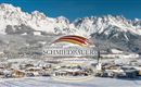 Eine malerische Winterlandschaft mit schneebedeckten Bergen und einem kleinen Dorf. Im Vordergrund ist das Appartement Schmiedbauer abgebildet.