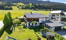 A beautiful house in a quiet environment, surrounded by green meadows and mountains. The garden has a swing and a trampoline.