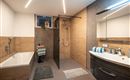 A modern bathroom with a shower and a bathtub. The walls are in neutral tones, complemented by stylish accessories.