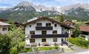 A charming building, our HOUSE ELISABETH, set against an impressive mountain backdrop of the Wild Kaiser in Ellmau.
