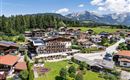 Exterior view of the Hotel Alpenpanorama in Söll with garden, terrace, and view of the Tyrolean mountains.
