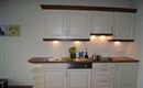 A modern country house kitchen with refrigerator, dishwasher, and fully automatic coffee machine awaits you