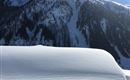 Rettensteinblick über verschneite Almhütte