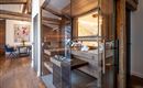 A modern sauna area with glass walls and wooden details. The room radiates a relaxing atmosphere.