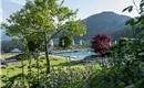 Söll-AlpenSchloessl-Hotel-Garten-Freischwimmbad