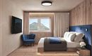 Ein modernes Schlafzimmer mit einem gemütlichen Bett und eleganten Holzdetails. Durch das Fenster ist eine malerische Berglandschaft sichtbar.
